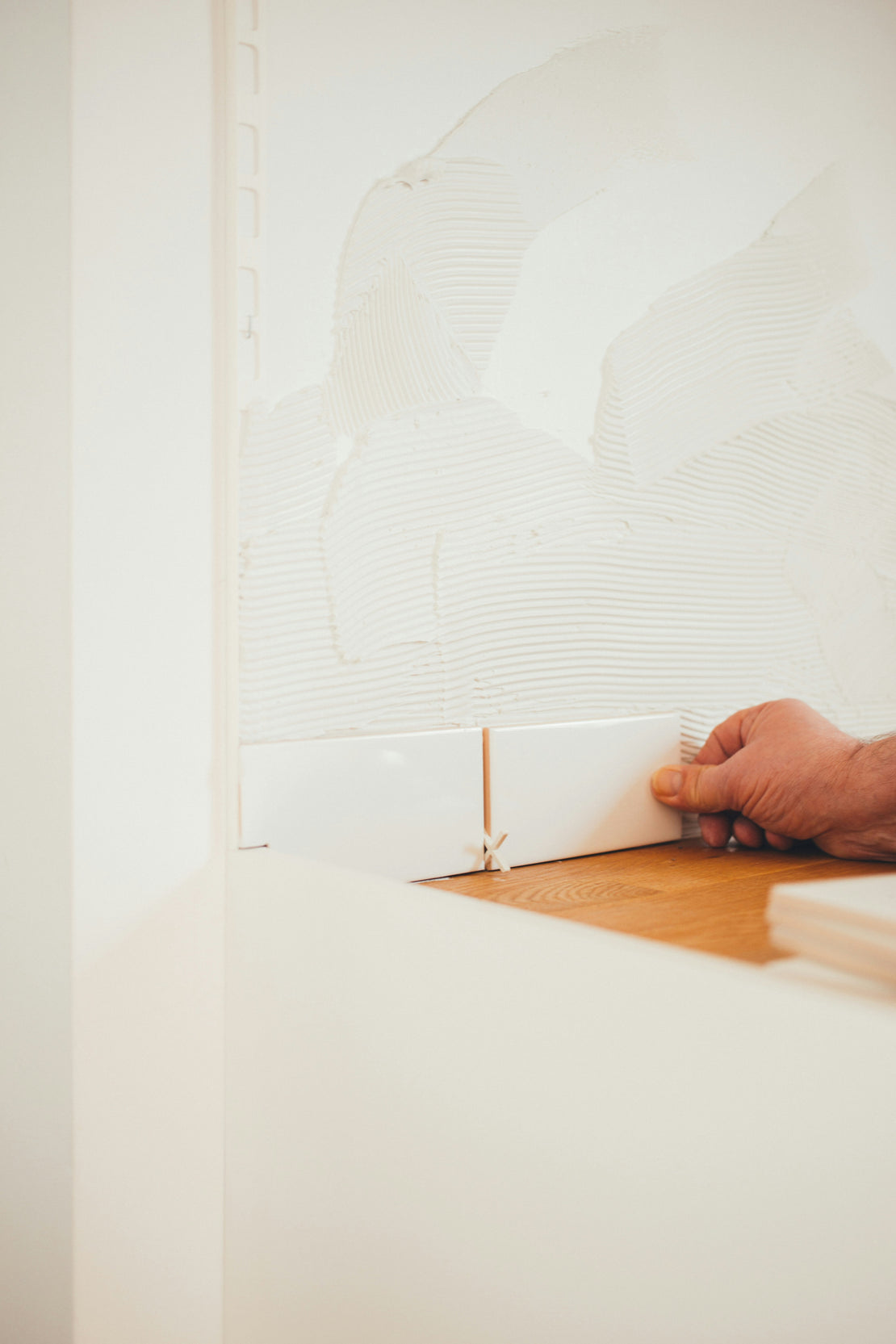 Person Laying Tile During Their Home Renovation Product